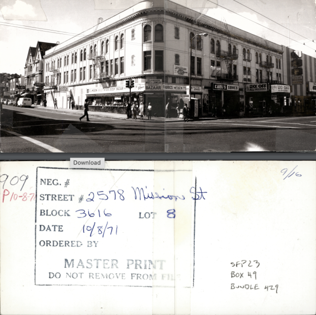 Black and white photo of the Mission Market building at 22nd and Mission, with storefronts including markets, a barber shop, and a shoe store. Handwritten notes and a master print stamp are on the back.